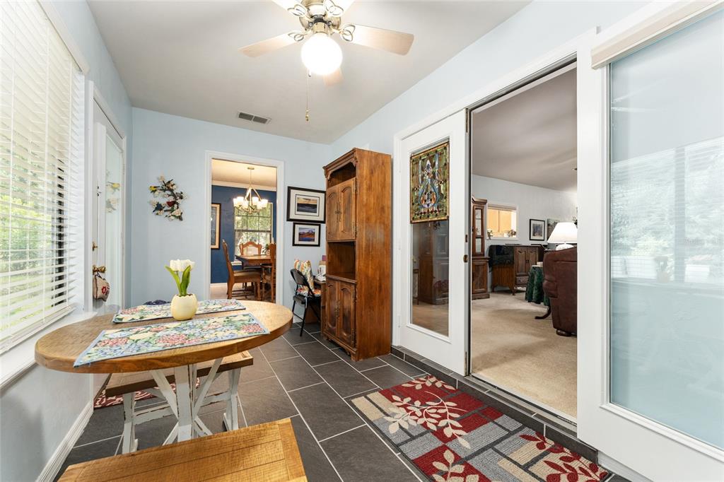 10922 Palmetto Boulevard Alachua, FL 32615 - Photo 33 of 51 a living room with furniture a rug and a chandelier
