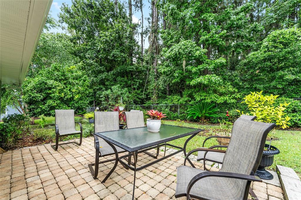 10922 Palmetto Boulevard Alachua, FL 32615 - Photo 35 of 51 a roof deck with table and chairs and potted plants