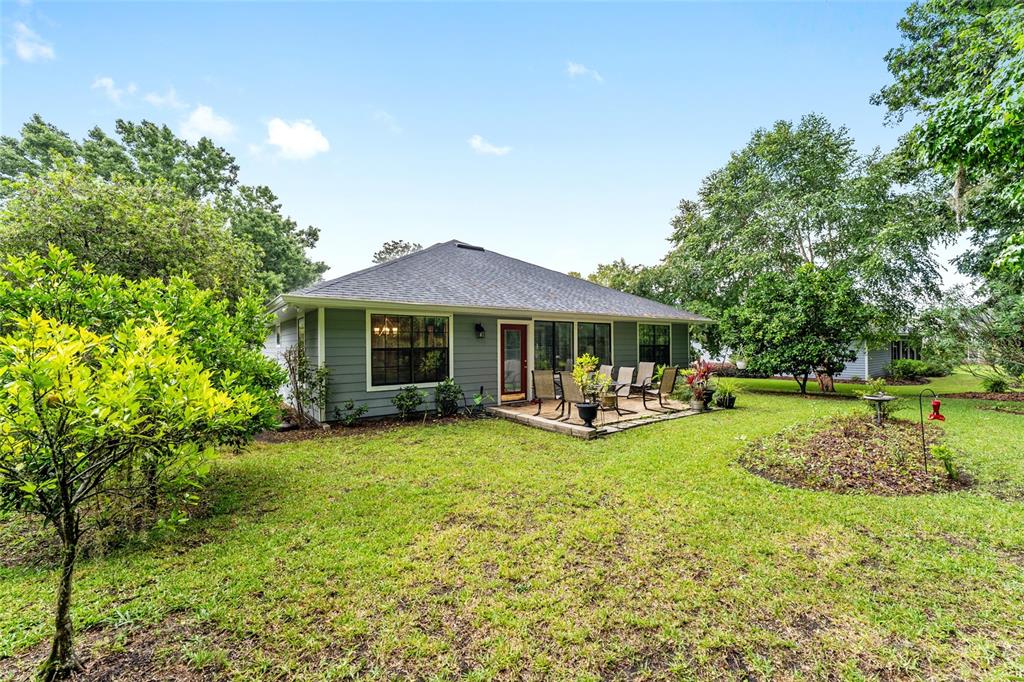 10922 Palmetto Boulevard Alachua, FL 32615 - Photo 37 of 51 a view of a house with swimming pool and sitting area