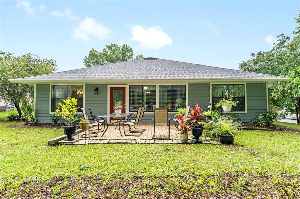 10922 Palmetto Boulevard Alachua, FL 32615 - Photo 38 of 51 a front view of house with yard and outdoor seating