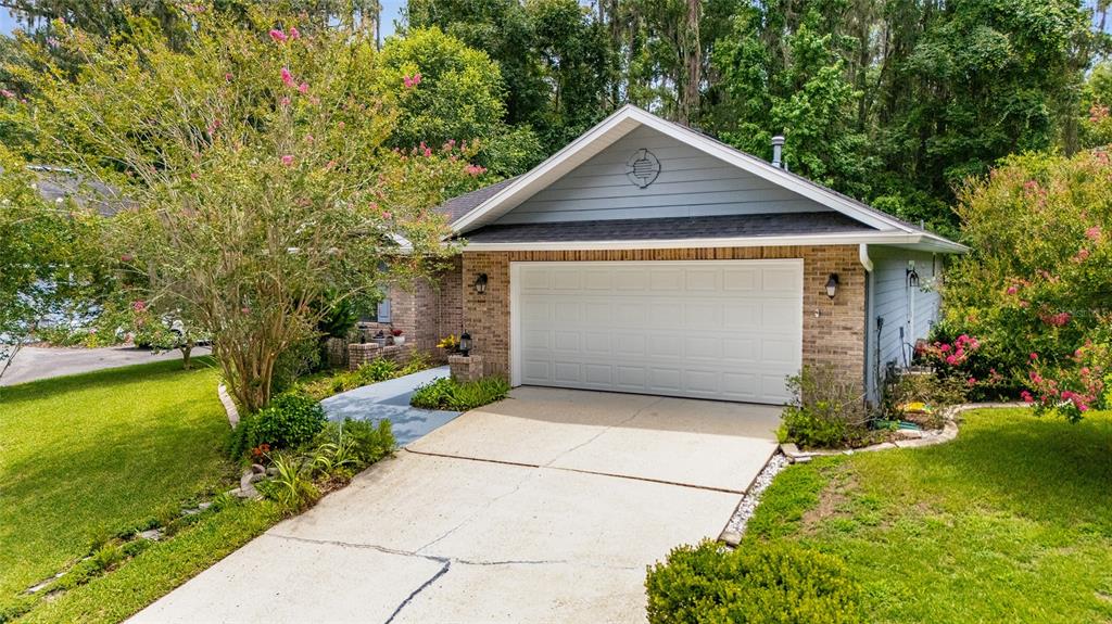 10922 Palmetto Boulevard Alachua, FL 32615 - Photo 39 of 51 a front view of a house with garden