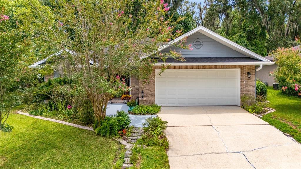 10922 Palmetto Boulevard Alachua, FL 32615 - Photo 40 of 51 a front view of a house with garden