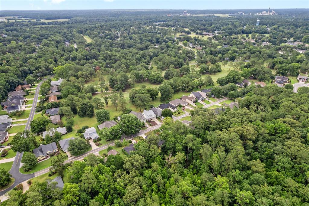 10922 Palmetto Boulevard Alachua, FL 32615 - Photo 47 of 51 an aerial view of a houses with a lush green hillside