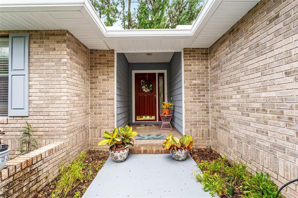 10922 Palmetto Boulevard Alachua, FL 32615 - Photo 5 of 51 a front view of a house with outdoor seating