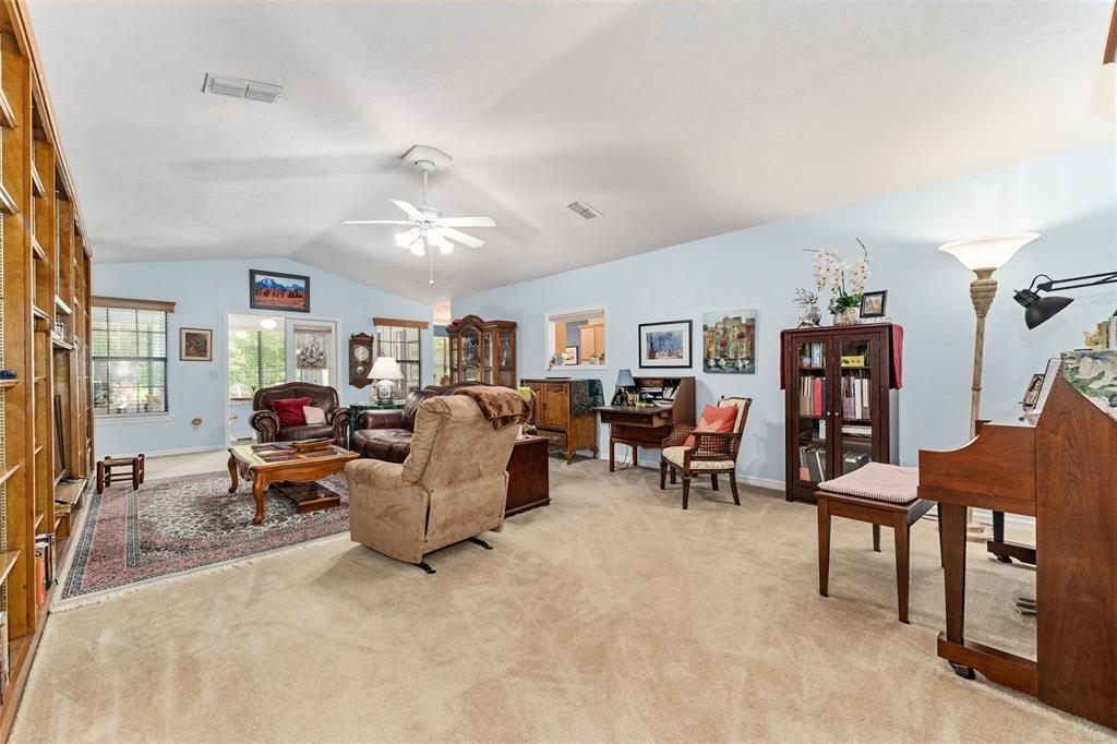 10922 Palmetto Boulevard Alachua, FL 32615 - Photo 7 of 51 a living room with furniture and a book shelf