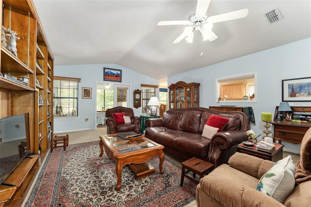 10922 Palmetto Boulevard Alachua, FL 32615 - Photo 8 of 51 a living room with furniture a flat screen tv and a window
