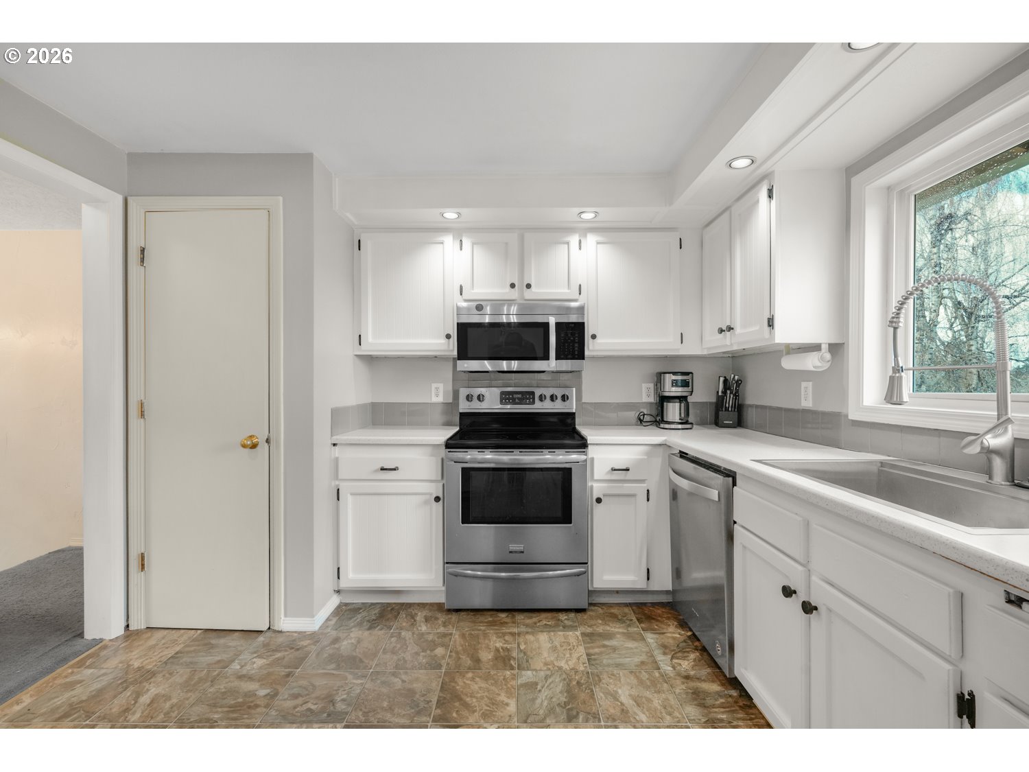1829 Southwest 17th Street Gresham, OR 97080 - Photo 11 of 27 a kitchen with a stove a sink and a microwave