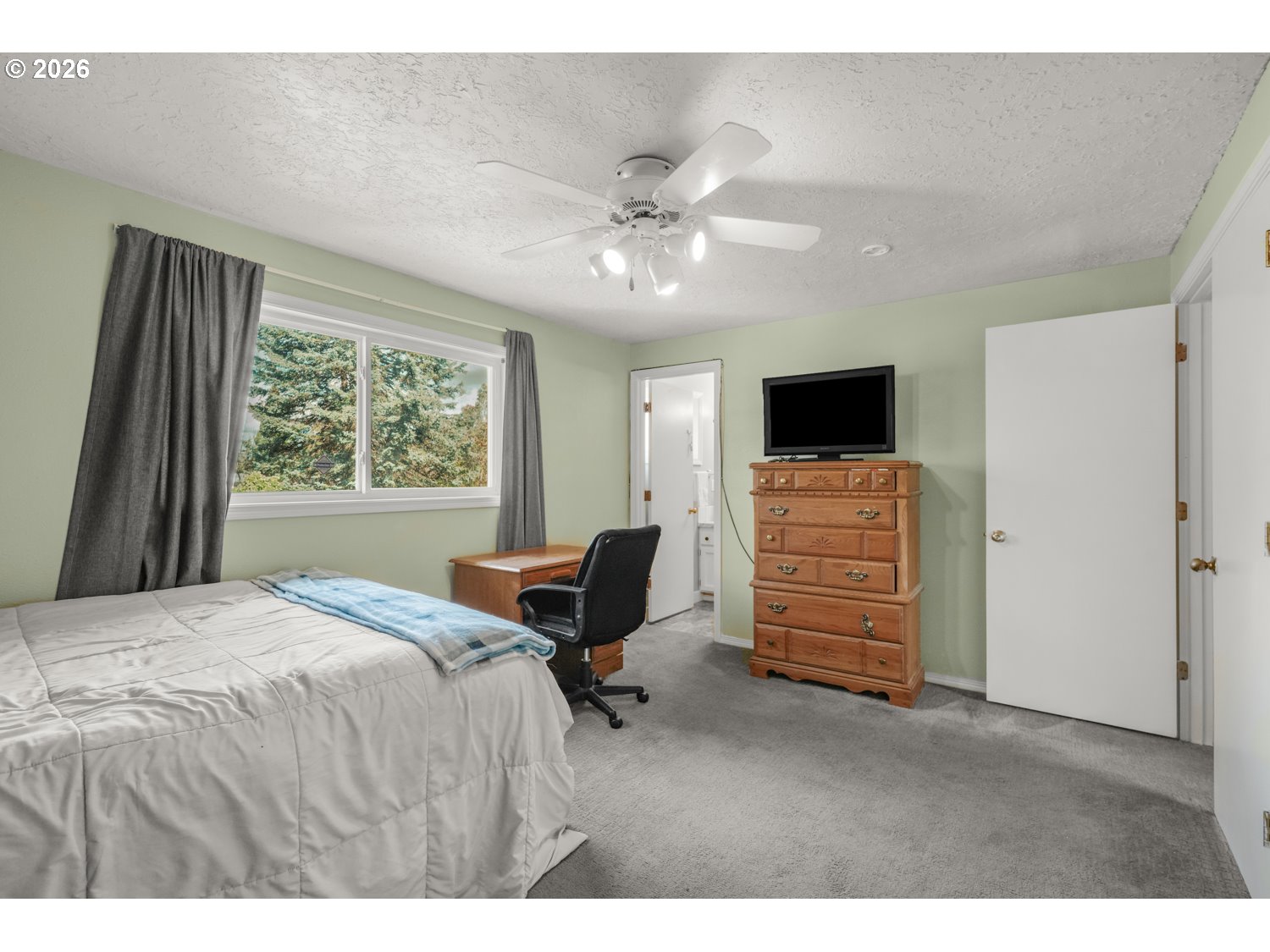 1829 Southwest 17th Street Gresham, OR 97080 - Photo 12 of 27 a bedroom with a bed and a television