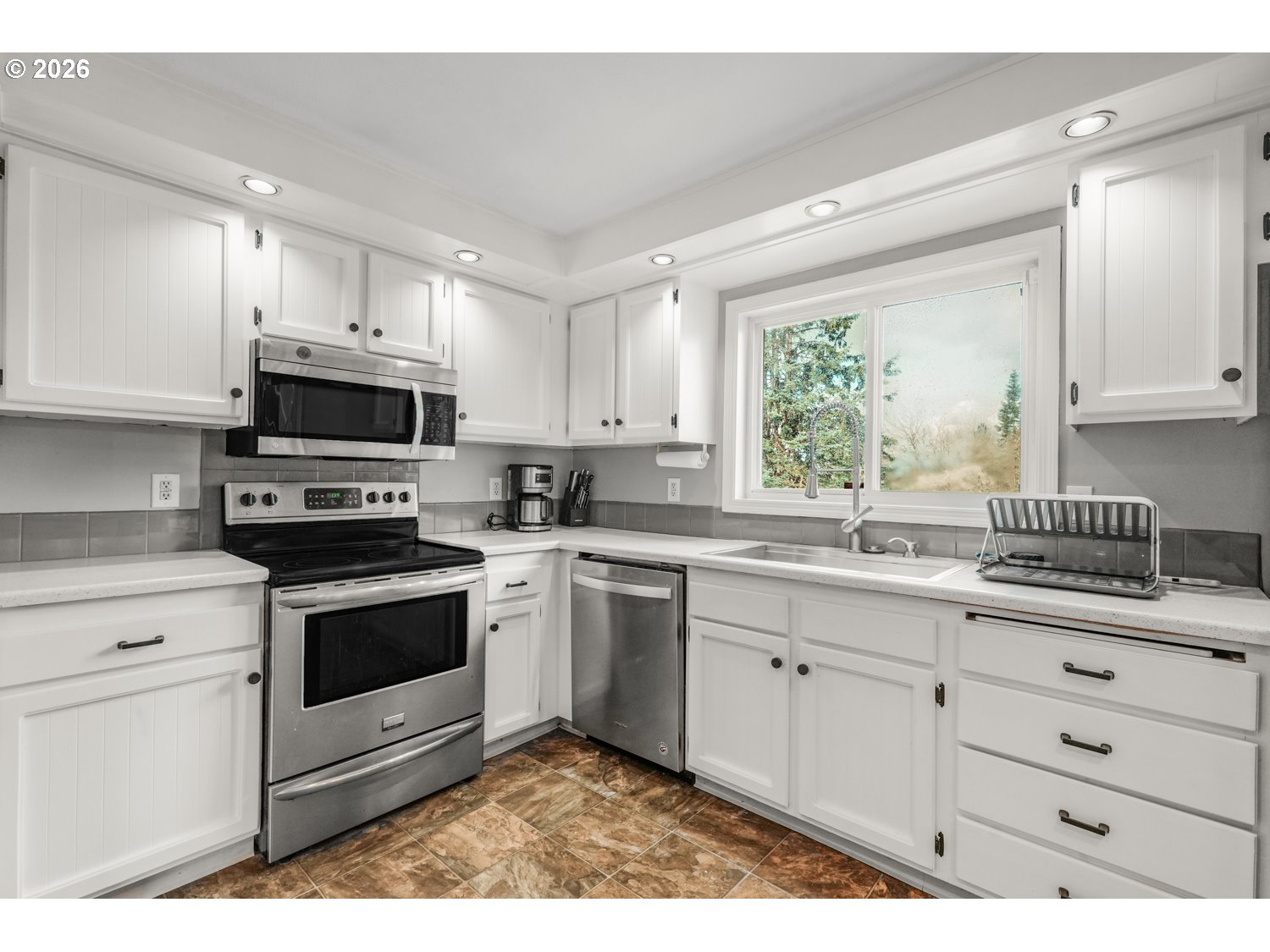 1829 Southwest 17th Street Gresham, OR 97080 - Photo 9 of 27 a kitchen with granite countertop a stove a sink and a microwave