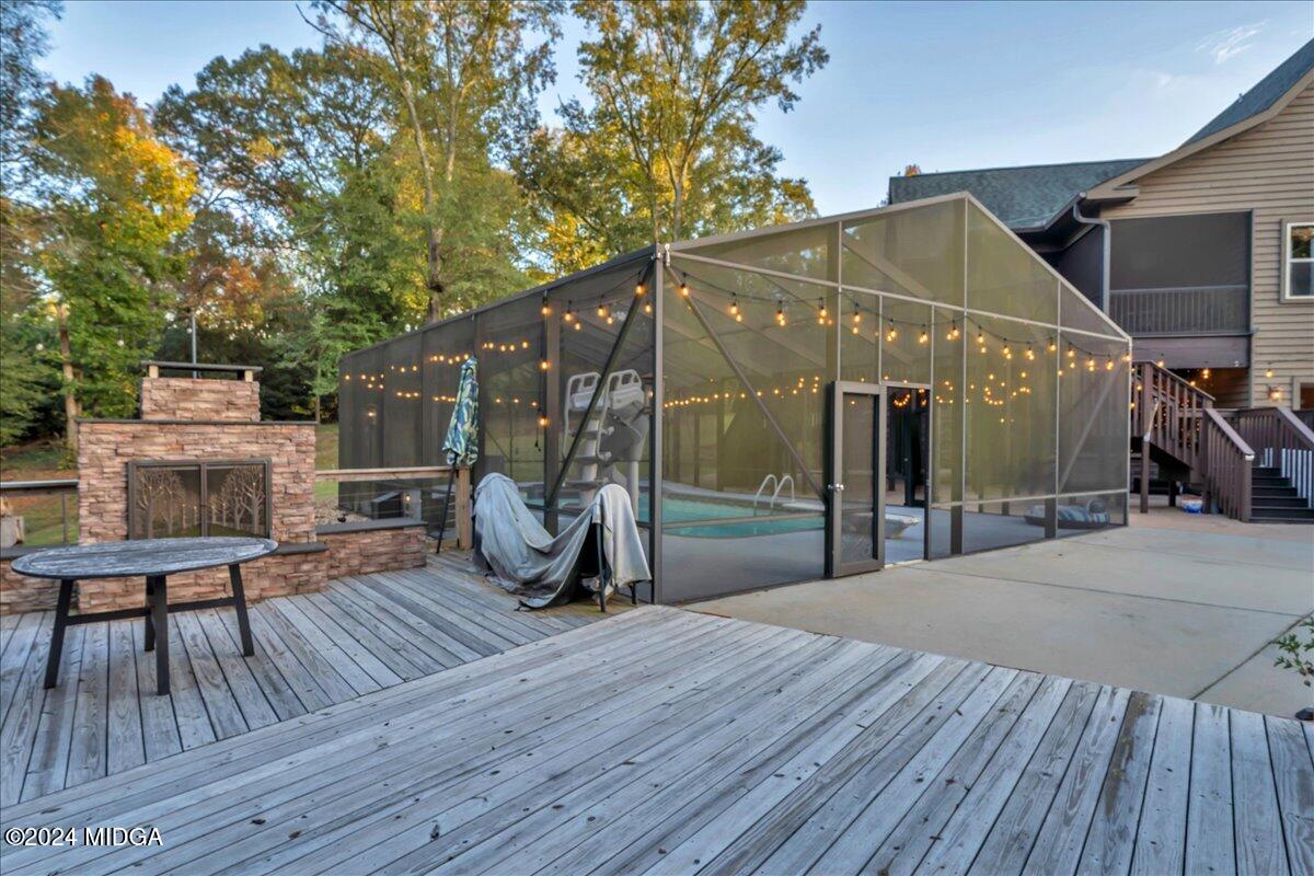 306 Thomson Street Centerville, GA 31028 - Photo 18 of 99 a view of a roof deck with table and chairs a barbeque with wooden floor and fence