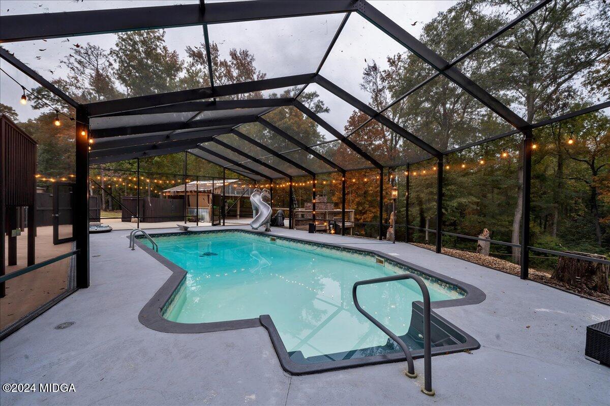 306 Thomson Street Centerville, GA 31028 - Photo 73 of 99 a view of a swimming pool with a patio and a backyard