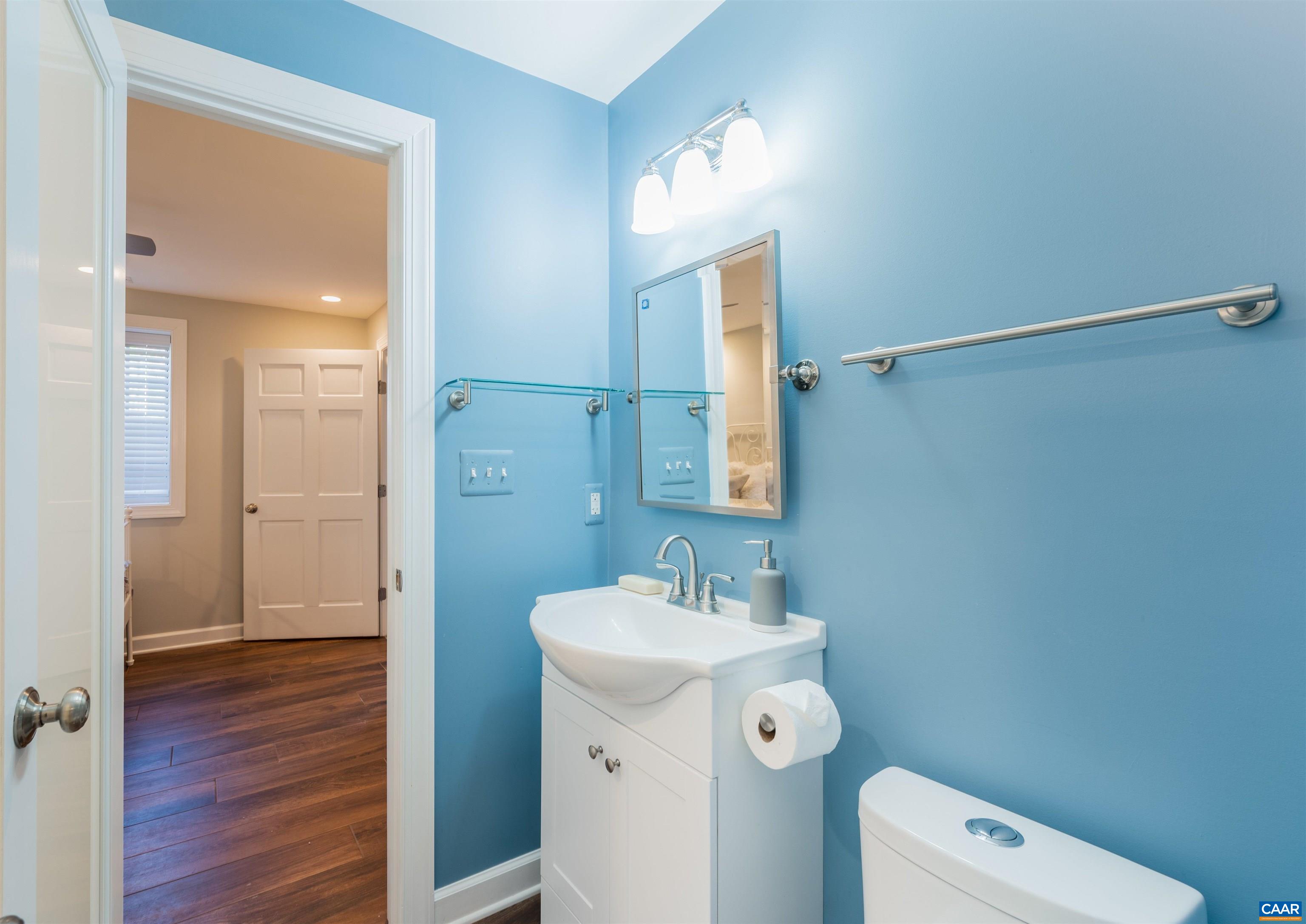 2600 Bennington Road Charlottesville, VA 22901 - Photo 42 of 60 a bathroom with a toilet a sink a mirror and vanity