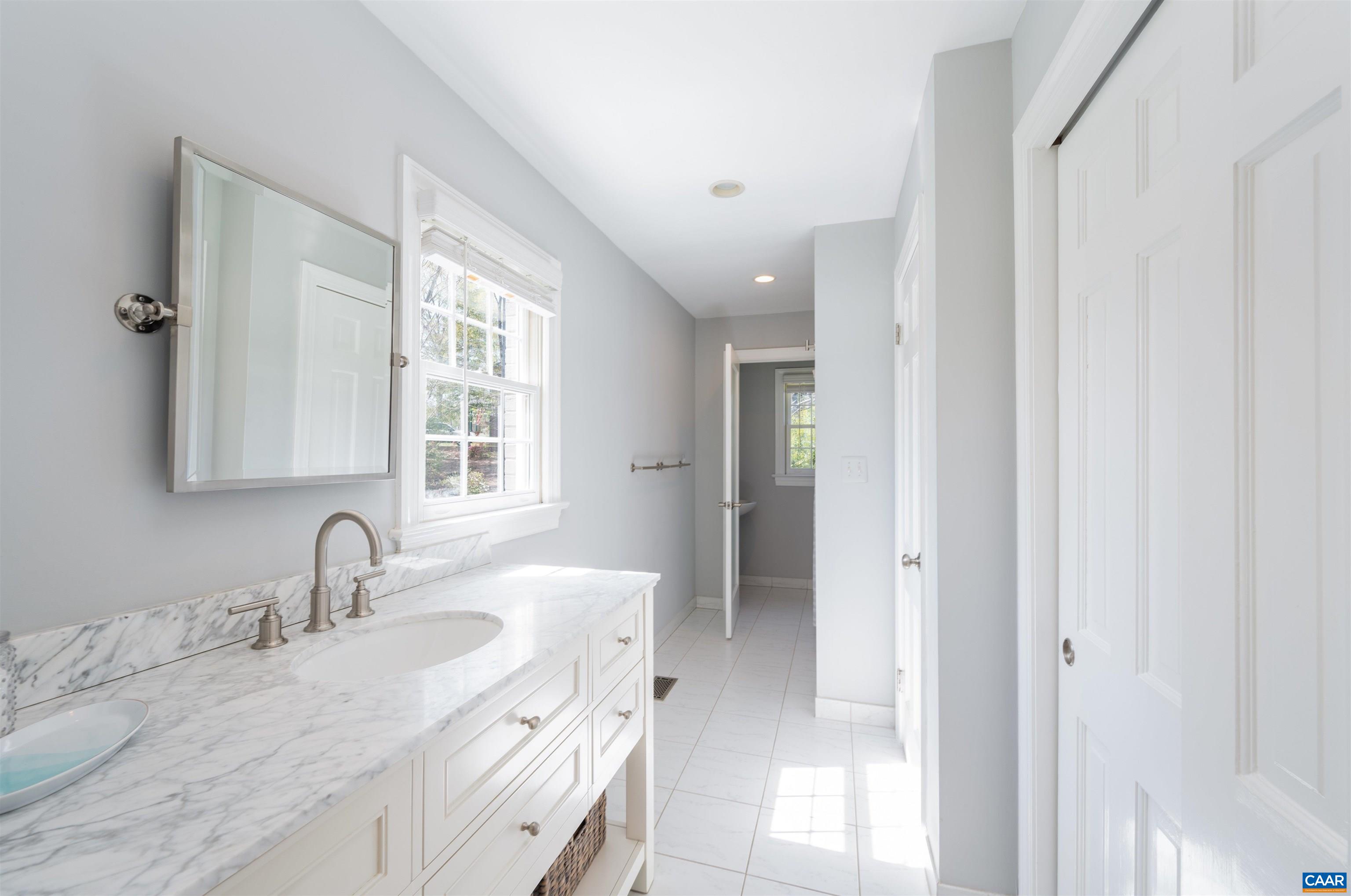 2600 Bennington Road Charlottesville, VA 22901 - Photo 6 of 60 a bathroom with double vanity sink a mirror and window