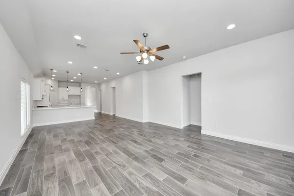 a view of an empty room and wooden floor