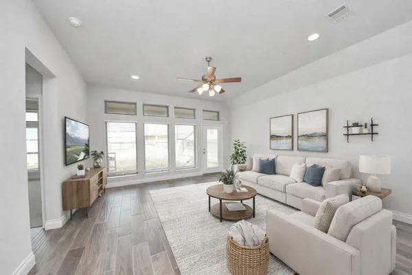 a bedroom with a large bed and potted plant