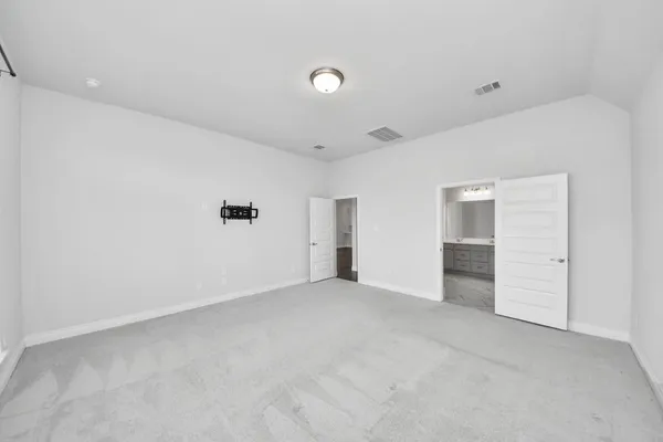 a spacious bathroom with a tub sink and mirror