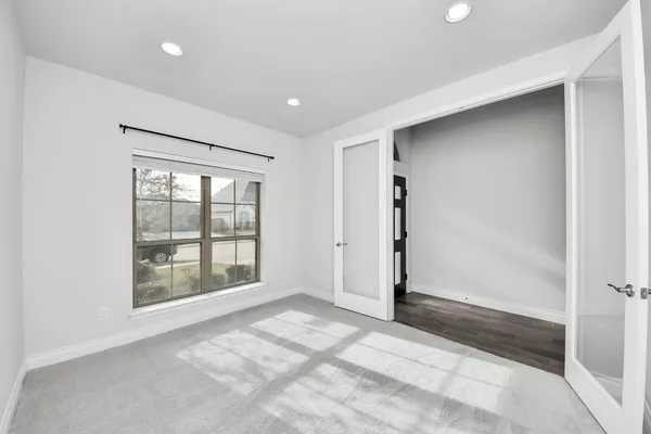a view of a room with wooden floor and white walls