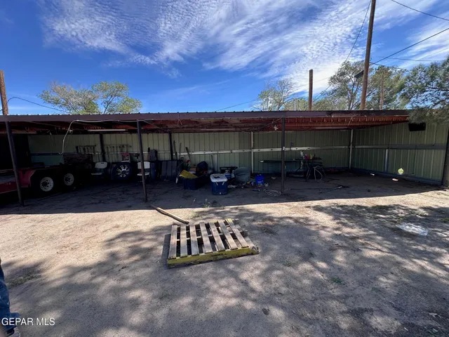 a view of patio with table and chairs a barbeque