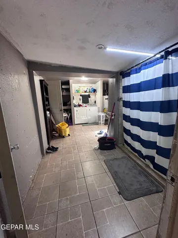 a view of a room with gym equipment and mirrors