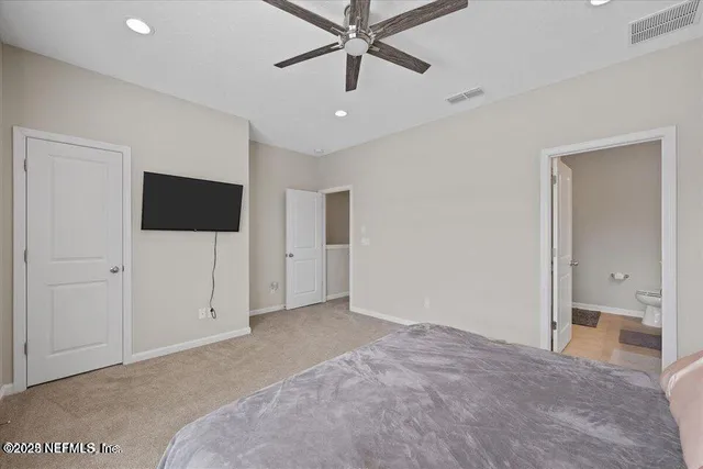 a view of a livingroom with a ceiling fan and entryway