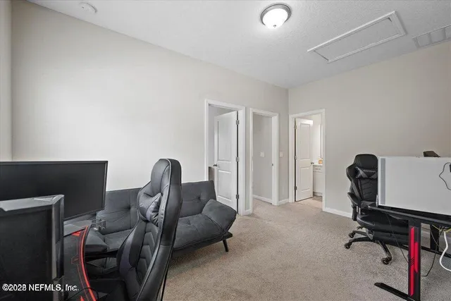 a view of livingroom with workspace and a couch