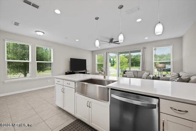 a kitchen that has a sink and a stove in it