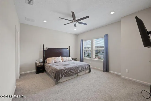 a bedroom with a bed and window