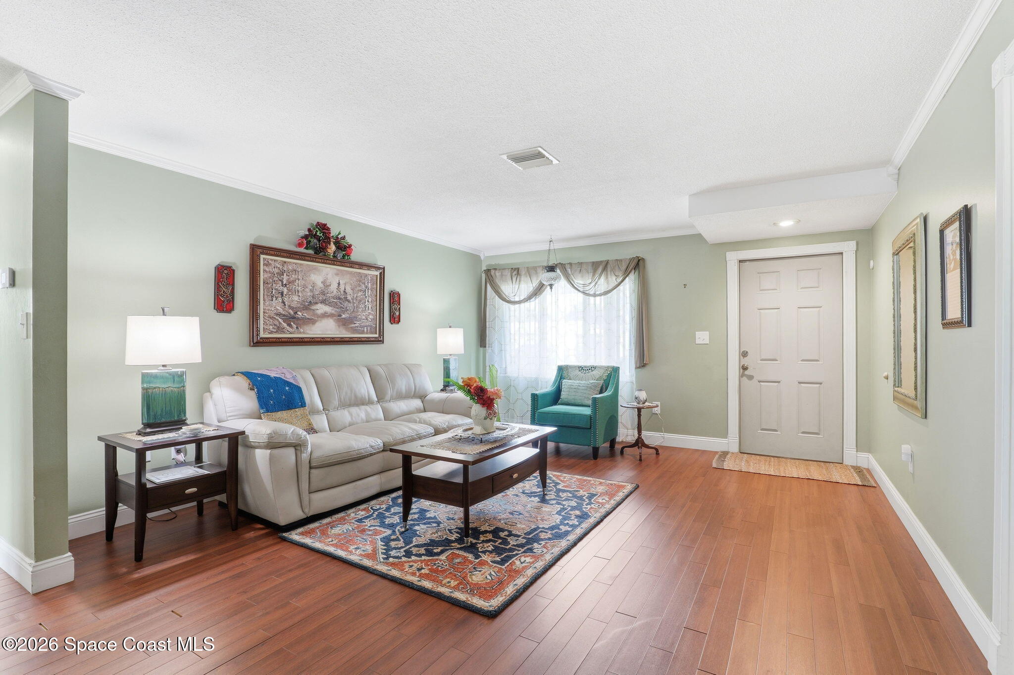 908 Jefferson Road Rockledge, FL 32955 - Photo 3 of 37 a living room with furniture wooden floor and a rug