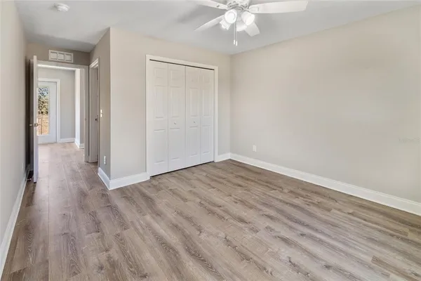 a view of a room with wooden floor