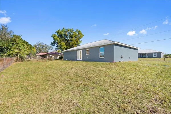 a view of an house with backyard space and tree