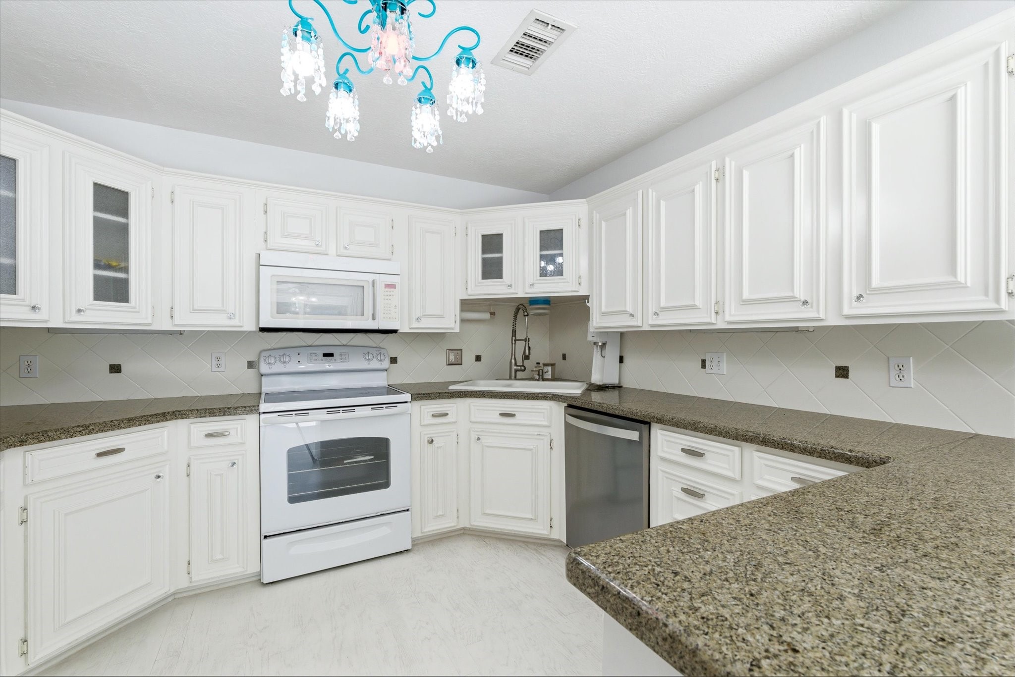 205 Don Q Baytown, TX 77523 - Photo 11 of 27 a kitchen with granite countertop white cabinets and white appliances