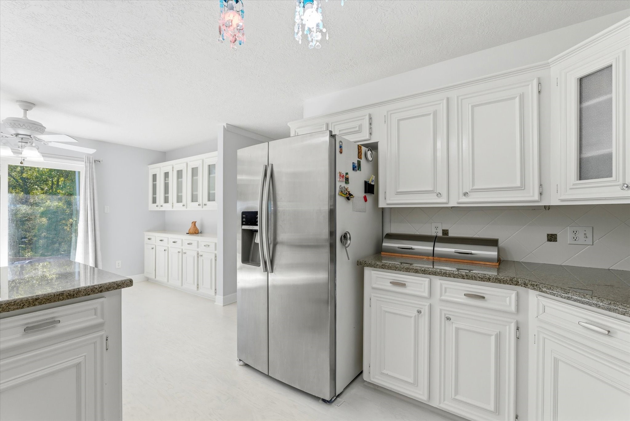 205 Don Q Baytown, TX 77523 - Photo 12 of 27 a kitchen with stainless steel appliances granite countertop a refrigerator a stove and white cabinets with a granite countertops