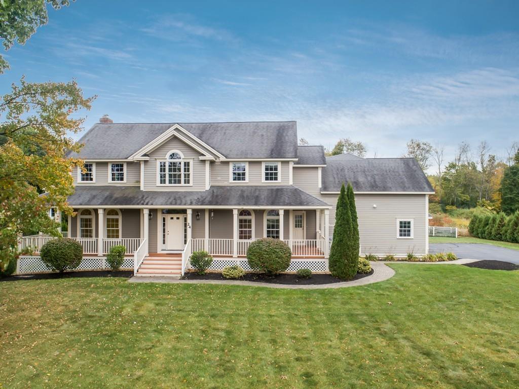 24 Village Road Pepperell, MA 01463 - Photo 1 of 40 a front view of a house with a yard