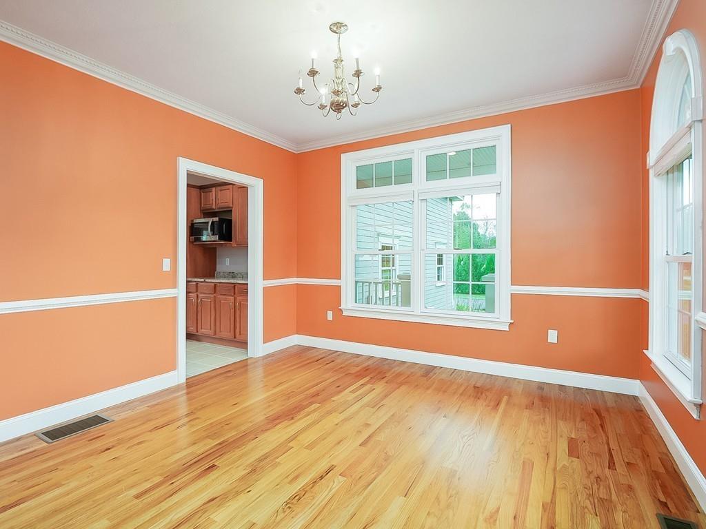 24 Village Road Pepperell, MA 01463 - Photo 13 of 40 a view of an empty room with a window and wooden floor