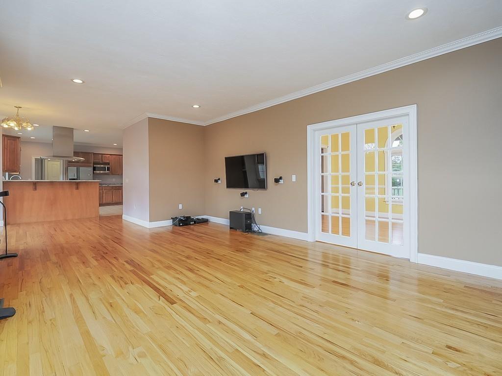 24 Village Road Pepperell, MA 01463 - Photo 16 of 40 a view of a living room a kitchen with stainless steel appliances wooden floor and view living room