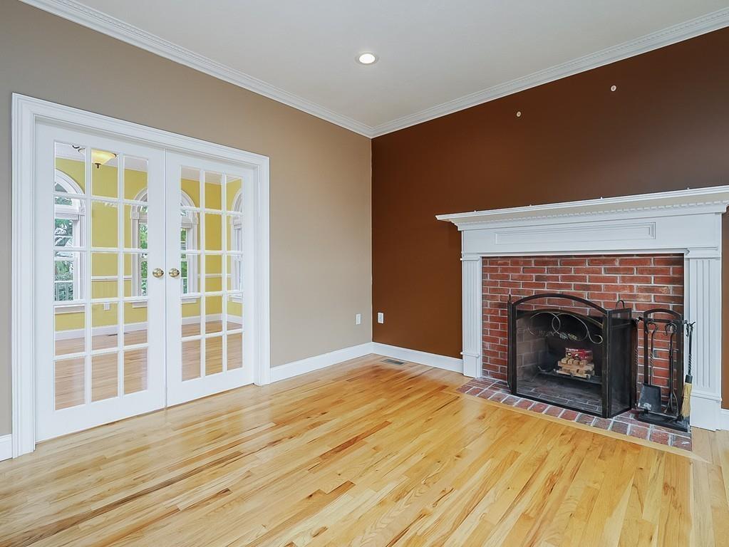 24 Village Road Pepperell, MA 01463 - Photo 17 of 40 a view of an empty room with wooden floor fireplace and a window