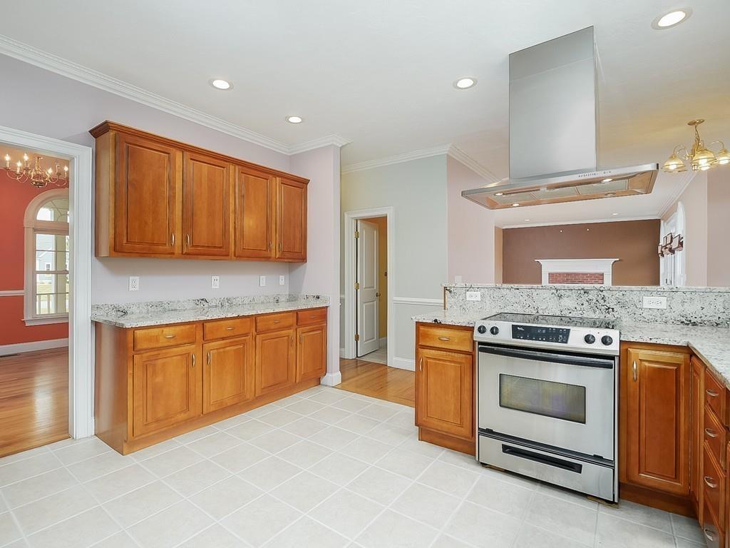 24 Village Road Pepperell, MA 01463 - Photo 20 of 40 a kitchen with stainless steel appliances granite countertop a stove and a sink