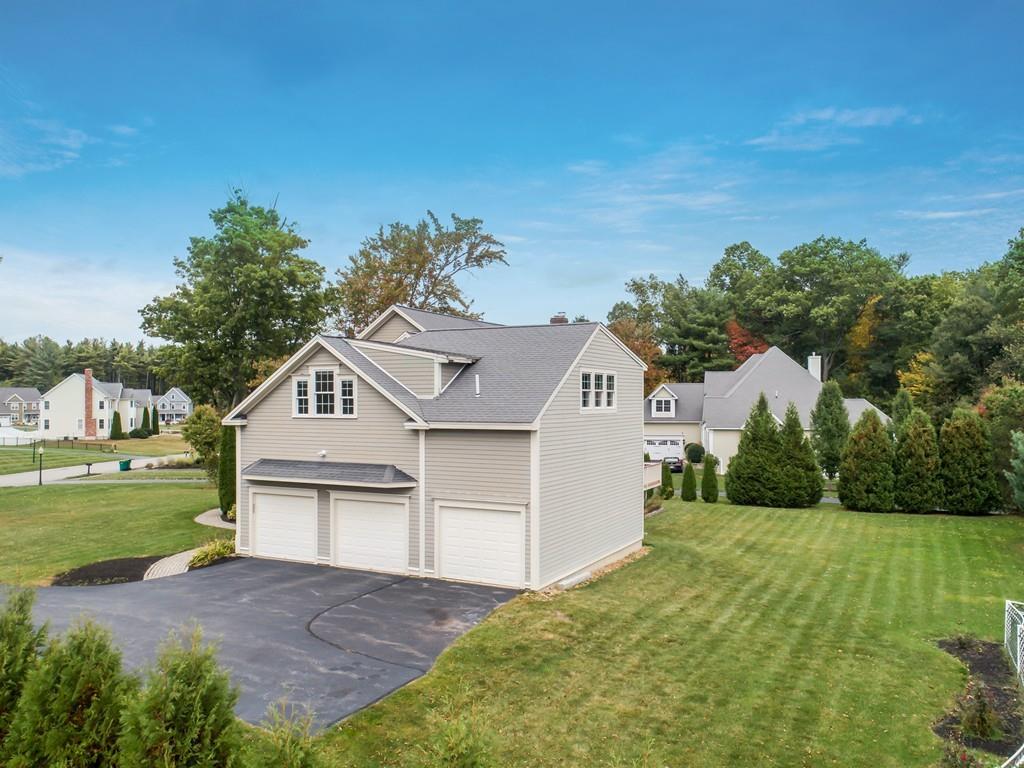 24 Village Road Pepperell, MA 01463 - Photo 2 of 40 a front view of a house with a yard