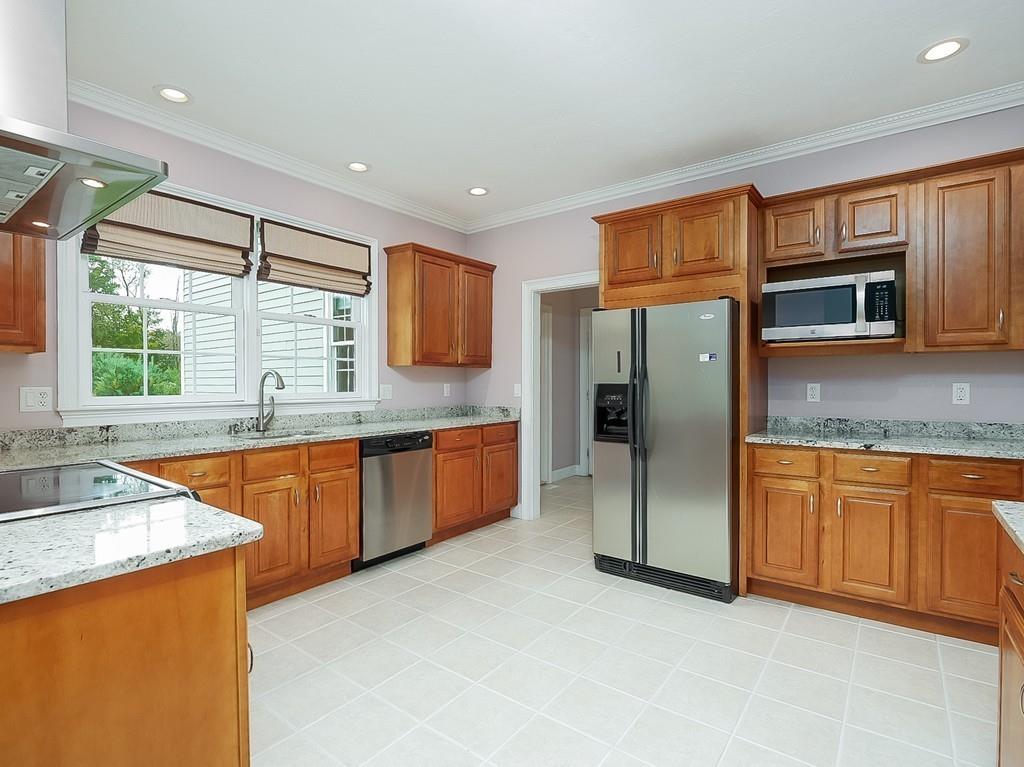 24 Village Road Pepperell, MA 01463 - Photo 21 of 40 a kitchen with stainless steel appliances granite countertop a sink stove and refrigerator