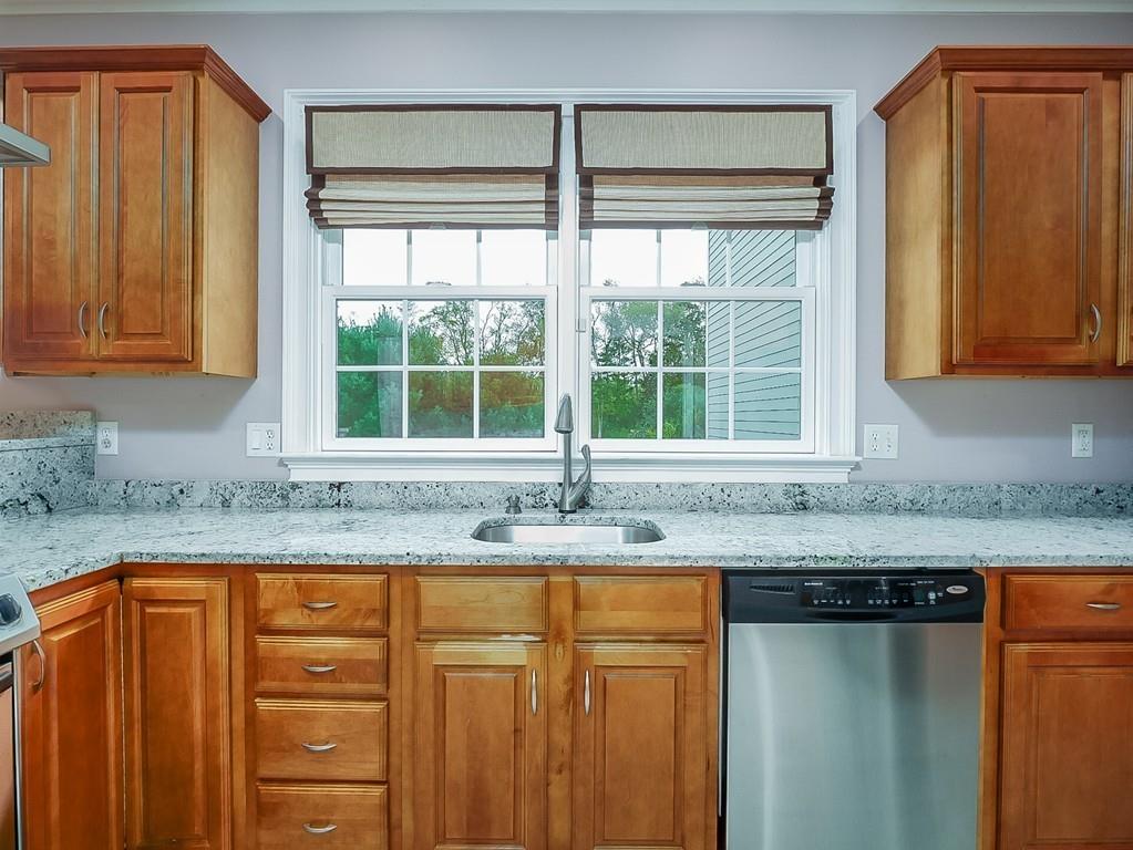24 Village Road Pepperell, MA 01463 - Photo 22 of 40 a kitchen with granite countertop cabinets sink and window