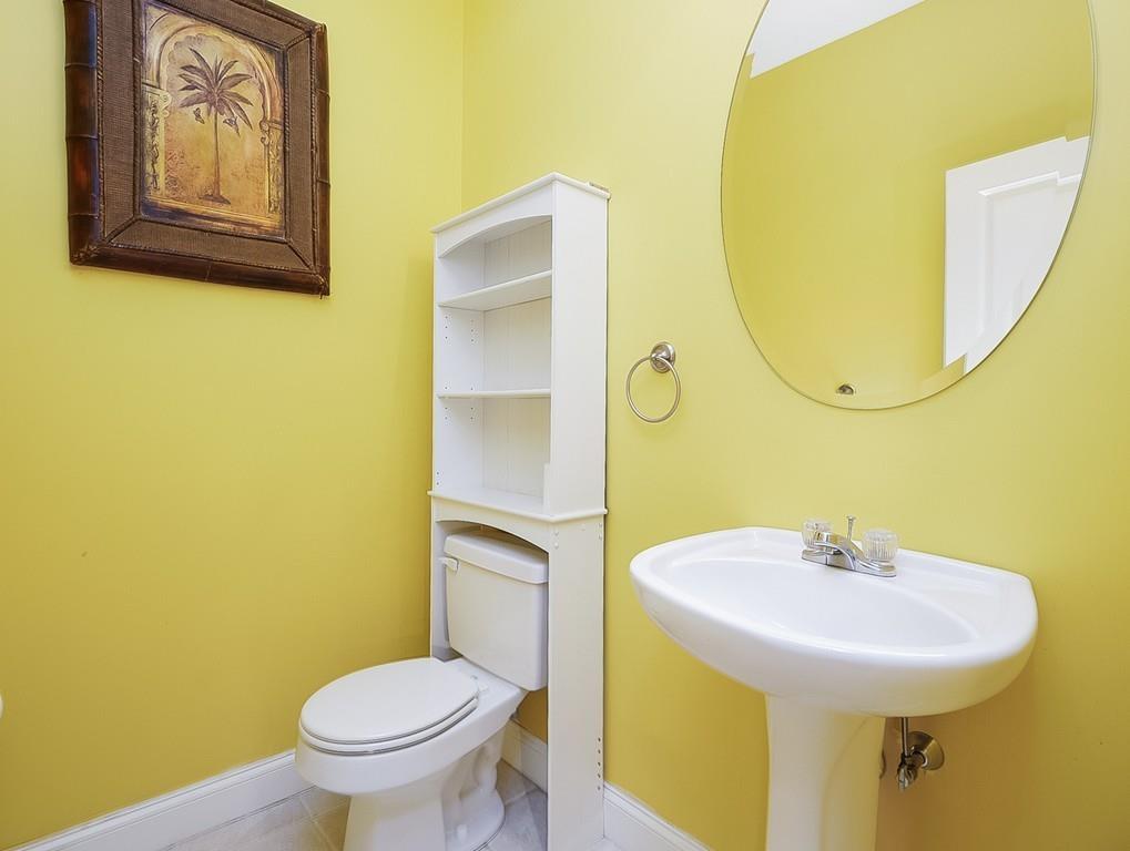 24 Village Road Pepperell, MA 01463 - Photo 24 of 40 a bathroom with a toilet sink and mirror