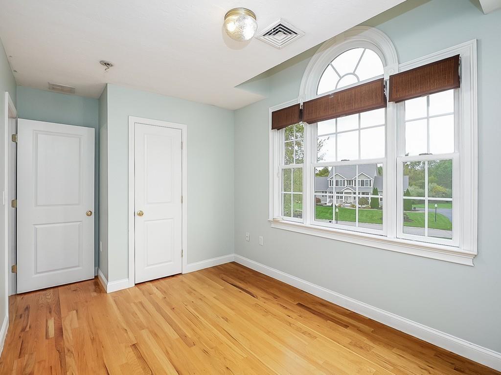 24 Village Road Pepperell, MA 01463 - Photo 25 of 40 a view of empty room with wooden floor and fan