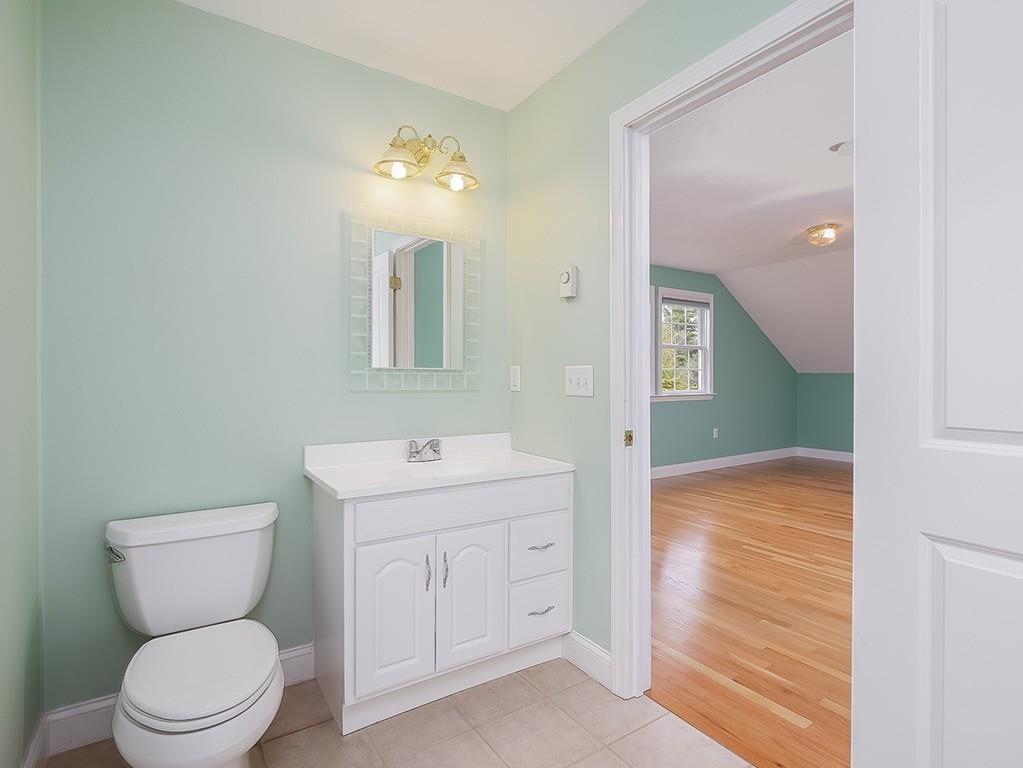 24 Village Road Pepperell, MA 01463 - Photo 29 of 40 a bathroom with a toilet sink and mirror
