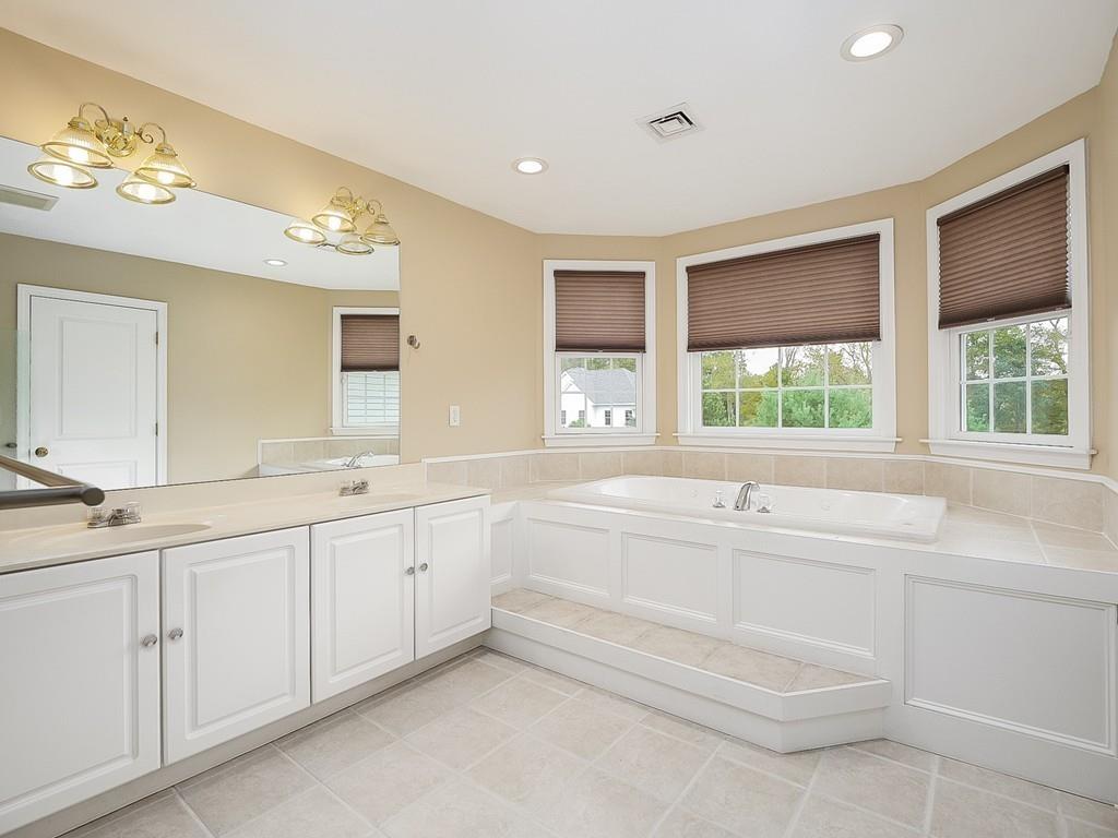 24 Village Road Pepperell, MA 01463 - Photo 30 of 40 a large white bathroom with a large tub sink and vanity