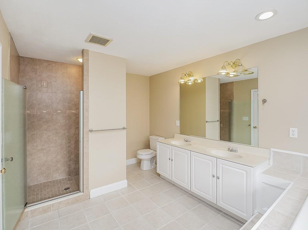 24 Village Road Pepperell, MA 01463 - Photo 31 of 40 a spacious bathroom with a double vanity sink a toilet and a mirror