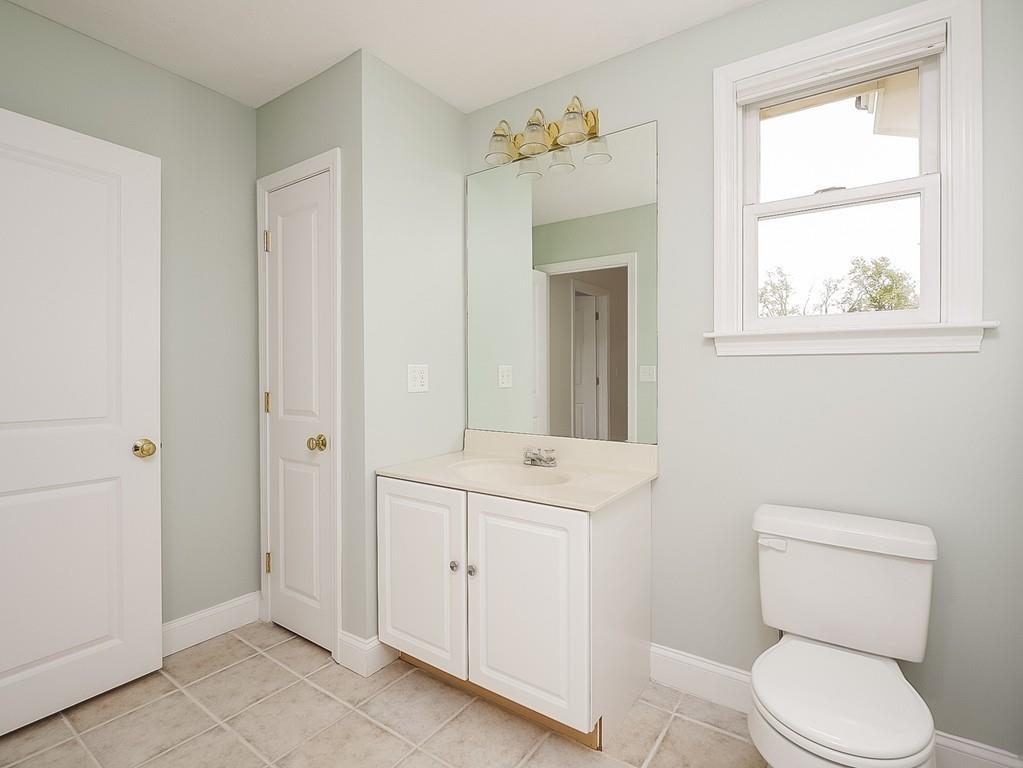 24 Village Road Pepperell, MA 01463 - Photo 32 of 40 a bathroom with a toilet a sink and a window