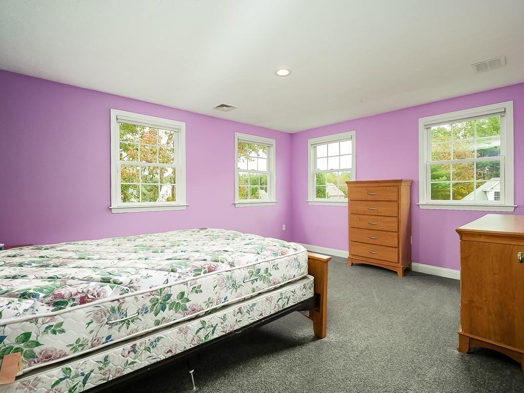 24 Village Road Pepperell, MA 01463 - Photo 35 of 40 a bed room with a bed and two windows