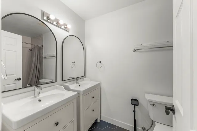 a bathroom with a double vanity sink and mirror