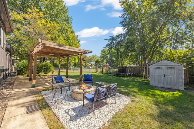 a view of a backyard with sitting area furniture and garden