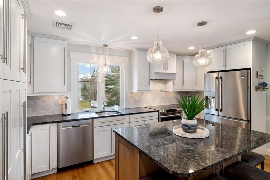 20 Bates Point Road Webster, MA 01570 - Photo 11 of 32 a kitchen with stainless steel appliances granite countertop counter space a sink a refrigerator a counter space and wooden floor